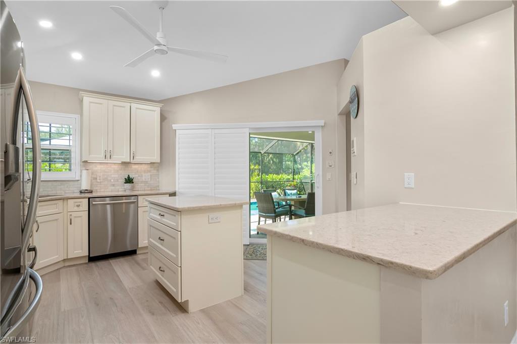 20771 Persimmon Place Estero, FL 33928 - Photo 12 of 50 a kitchen with a stove a sink and a refrigerator