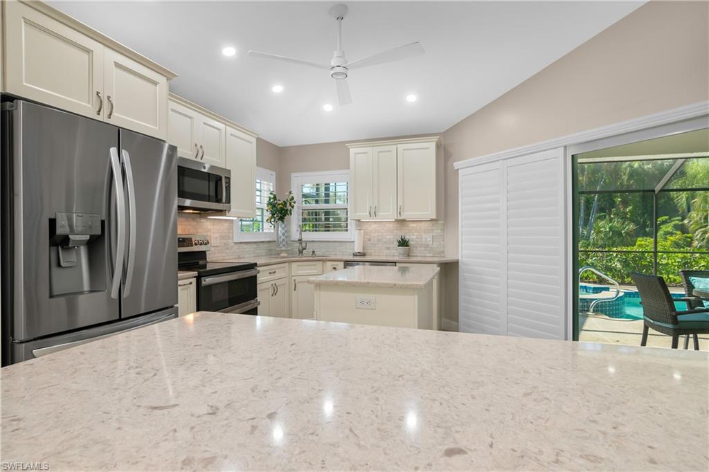 20771 Persimmon Place Estero, FL 33928 - Photo 13 of 50 a large kitchen with a large window and stainless steel appliances