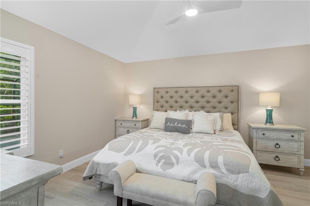 20771 Persimmon Place Estero, FL 33928 - Photo 19 of 50 a bedroom with a bed and a lamp