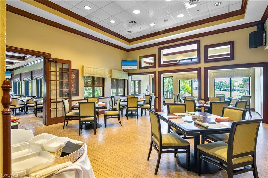20771 Persimmon Place Estero, FL 33928 - Photo 36 of 50 a dining room with furniture a large window and a chandelier