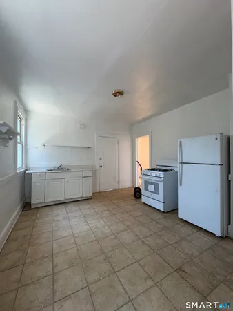 a view of a kitchen with a sink dishwasher and a refrigerator