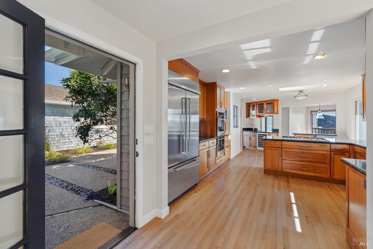 500 Ridge Road Tiburon, CA 94920 - Photo 17 of 42 a view of a large kitchen with kitchen island granite countertop wooden floor and a counter top space