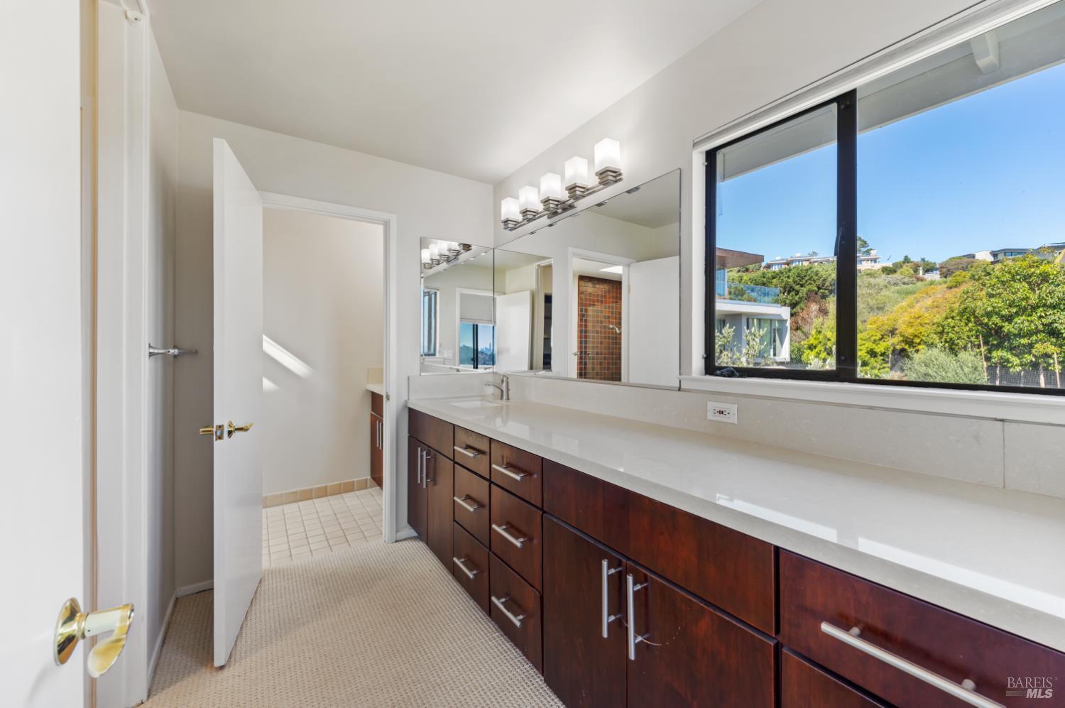 500 Ridge Road Tiburon, CA 94920 - Photo 25 of 42 a spacious bathroom with a granite countertop sink mirror and a shower