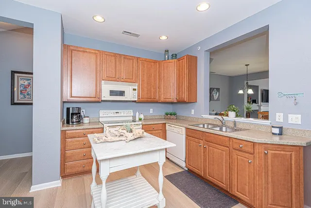 a kitchen with stainless steel appliances granite countertop a sink stove and microwave