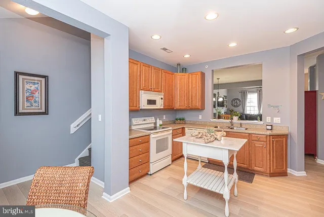 a kitchen with a sink appliances and cabinets