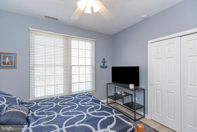 a living room with a flat screen tv and a window