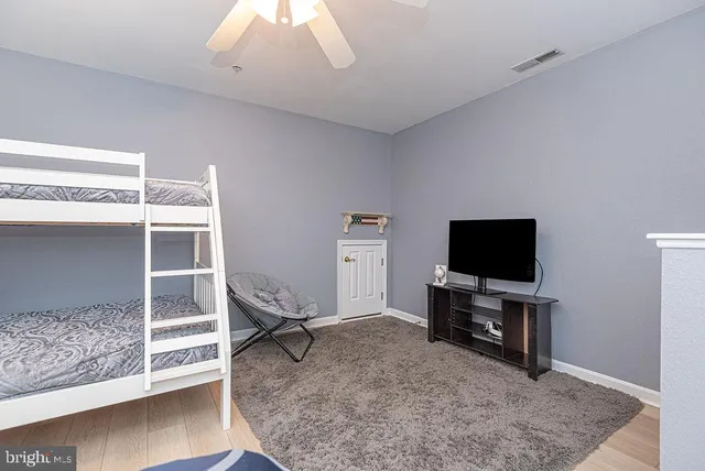 a living room with a flat screen tv and a rug