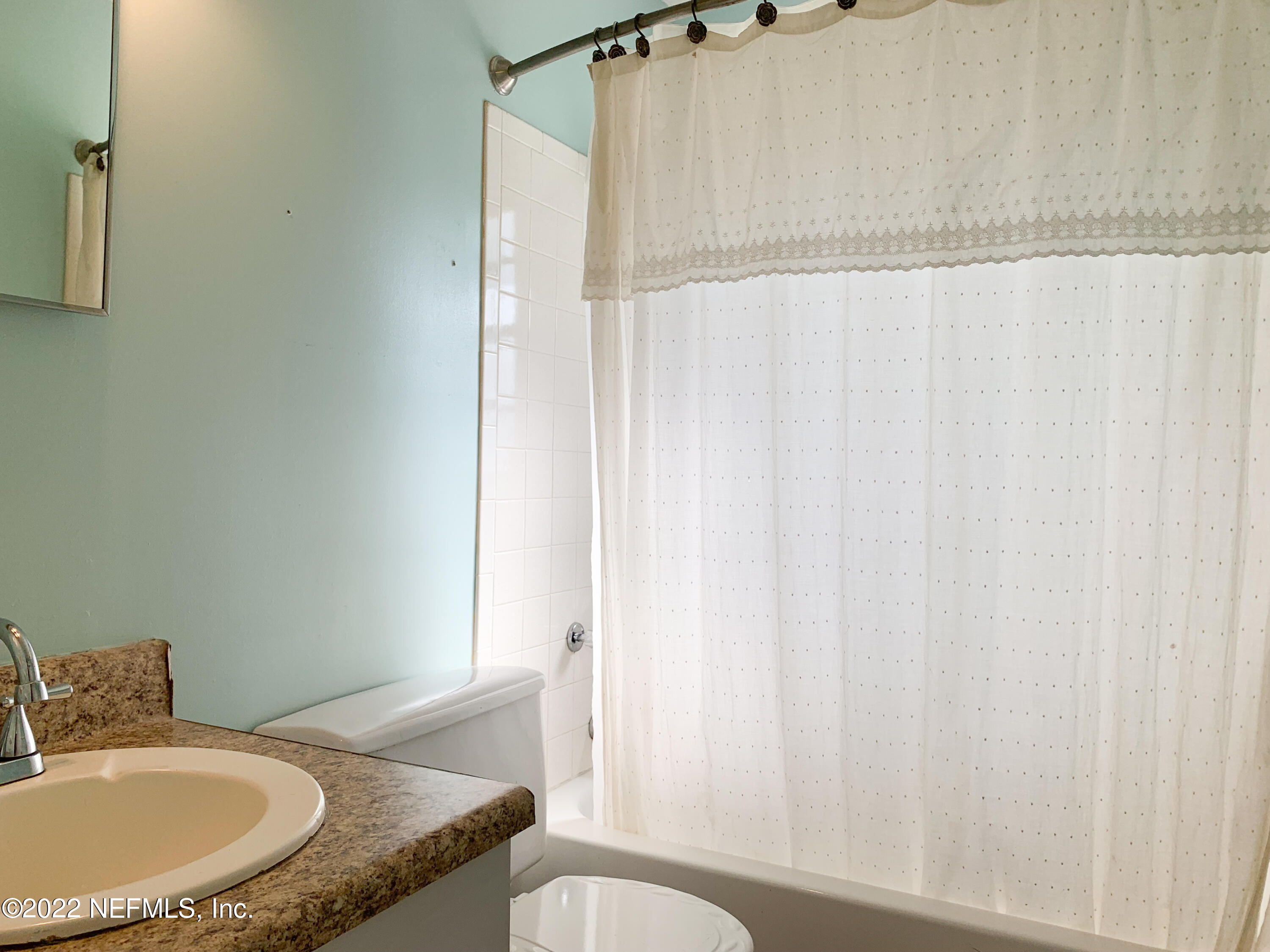 6771 Deer Springs Road Keystone Heights, FL 32656 - Photo 11 of 23 a bathroom with a granite countertop sink and a mirror