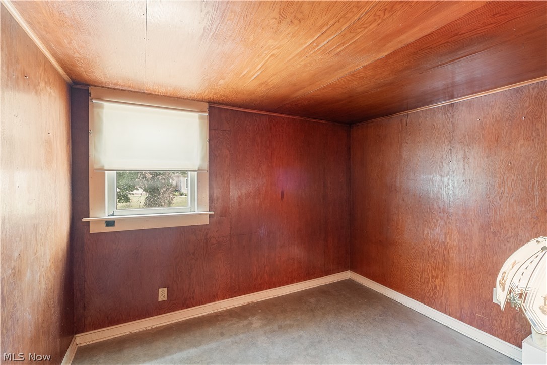 6324 Struthers Road Youngstown, OH 44514 - Photo 37 of 42 Room featuring wood paneling on walls and ceiling