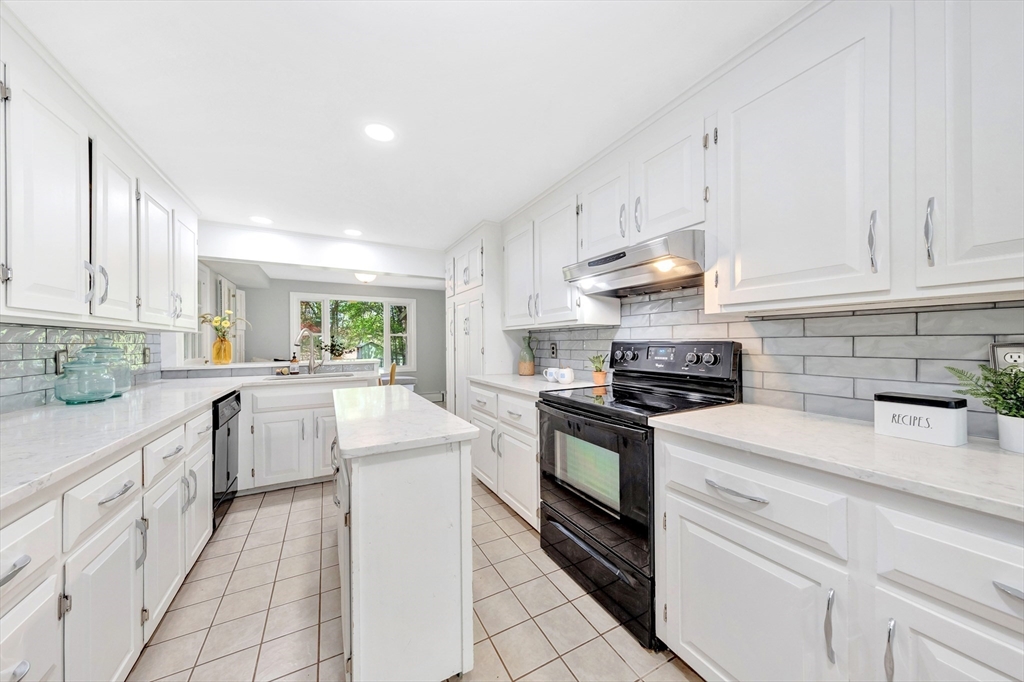 26 Andover Road Billerica, MA 01821 - Photo 27 of 40 a kitchen with white cabinets and appliances