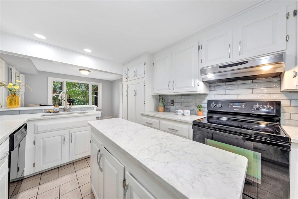 26 Andover Road Billerica, MA 01821 - Photo 28 of 40 a kitchen with granite countertop a stove sink and cabinets
