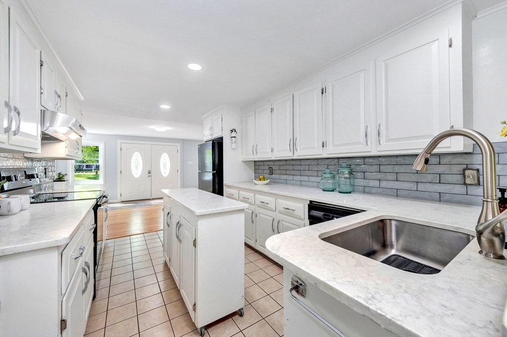 26 Andover Road Billerica, MA 01821 - Photo 30 of 40 a kitchen that has a sink and a stove in it