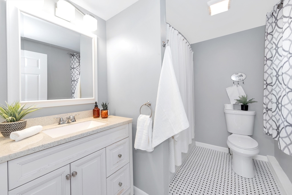 26 Andover Road Billerica, MA 01821 - Photo 34 of 40 a bathroom with a sink a toilet and a mirror