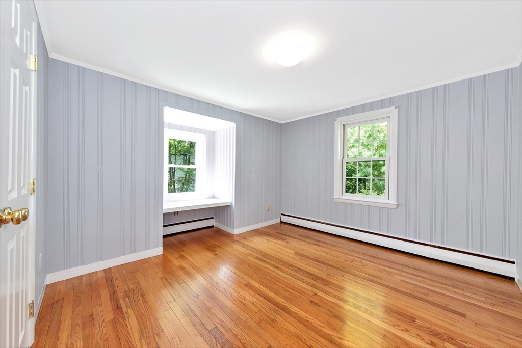 26 Andover Road Billerica, MA 01821 - Photo 36 of 40 an empty room with wooden floor and windows