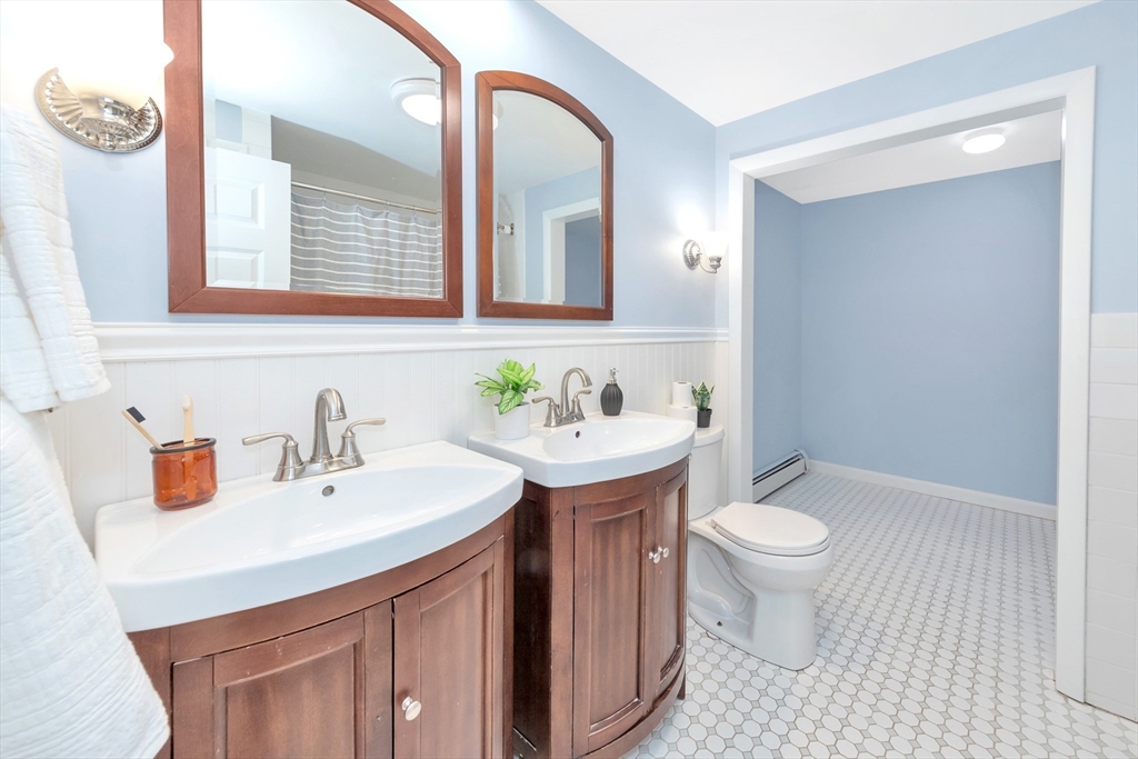 26 Andover Road Billerica, MA 01821 - Photo 39 of 40 a bathroom with a sink toilet a mirror and vanity