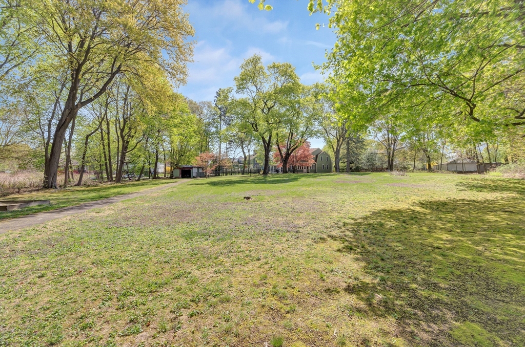 26 Andover Road Billerica, MA 01821 - Photo 6 of 40 a view of a field with trees in the background
