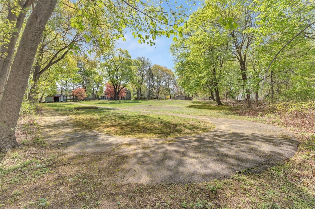 26 Andover Road Billerica, MA 01821 - Photo 7 of 40 a view of a field with trees in the background