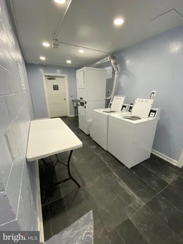 a view of a room with table and chairs