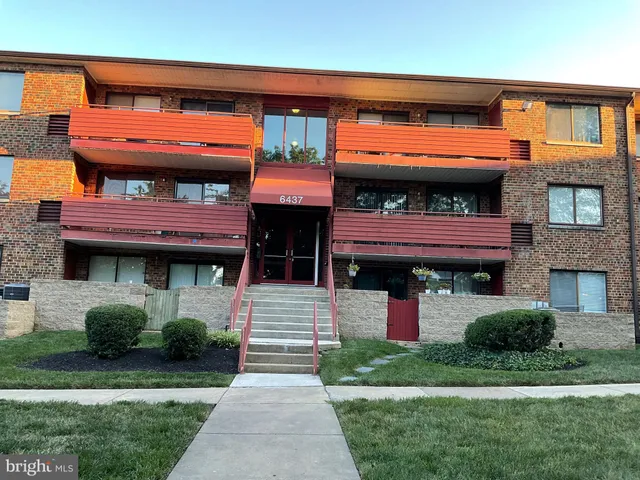a front view of a house with a garden and plants
