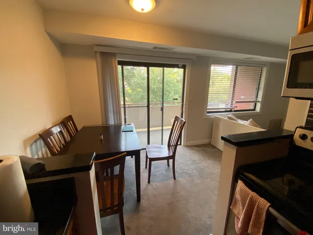 a kitchen with granite countertop cabinets stove and microwave