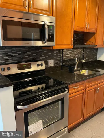 a kitchen with a refrigerator stove and sink