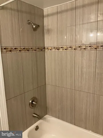 a bathroom with a granite countertop sink mirror vanity and toilet