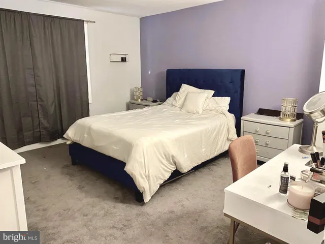 a bedroom with bed and a table