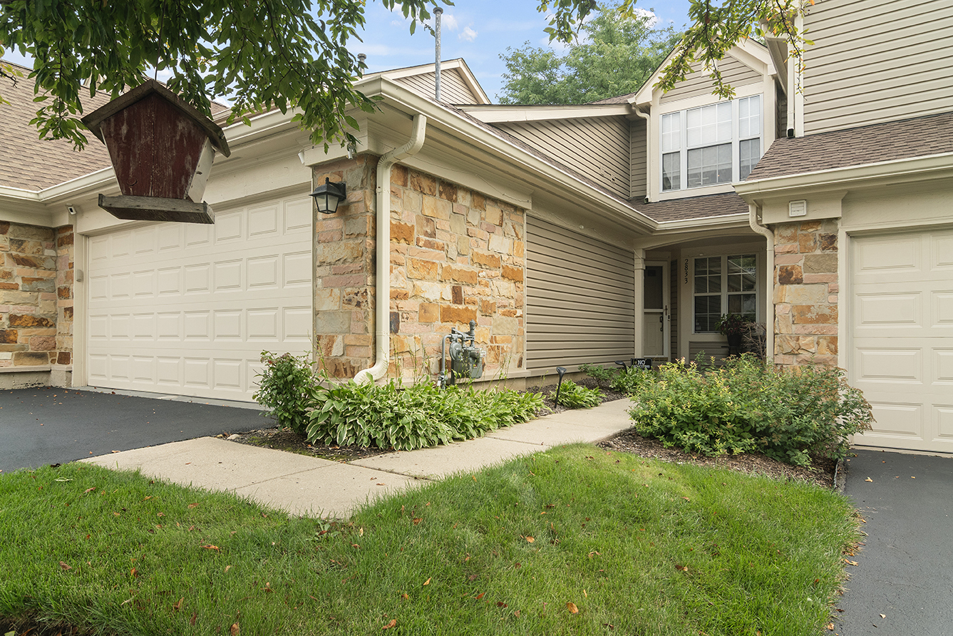 2833 Belle Lane, Unit 2833 Schaumburg, IL 60193 - Photo 1 of 23 a front view of a house with garden