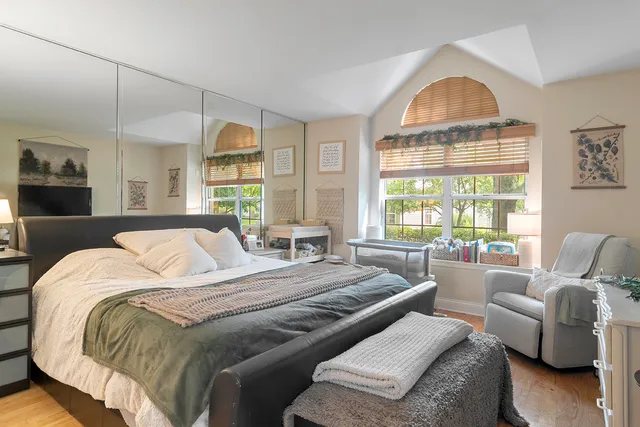 a bedroom with a bed a couch and a window