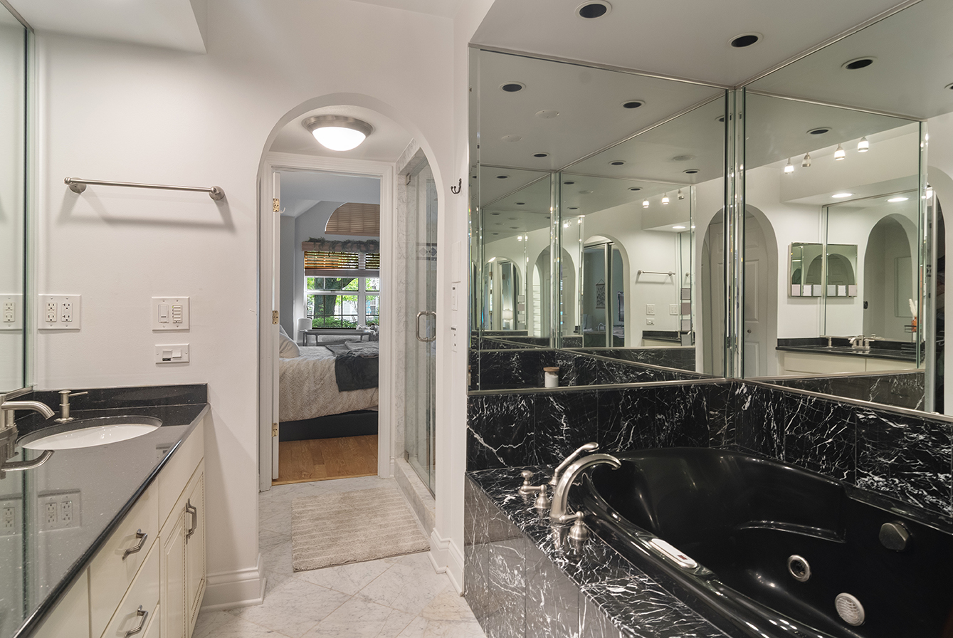 2833 Belle Lane, Unit 2833 Schaumburg, IL 60193 - Photo 14 of 23 a bathroom with a double vanity sink a large mirror and shower