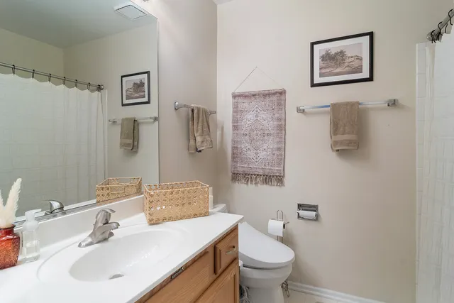 a bathroom with a sink toilet and a mirror
