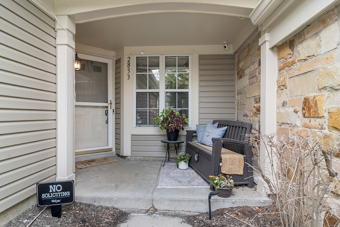 2833 Belle Lane, Unit 2833 Schaumburg, IL 60193 - Photo 2 of 23 a view of a patio with table and chairs and potted plants