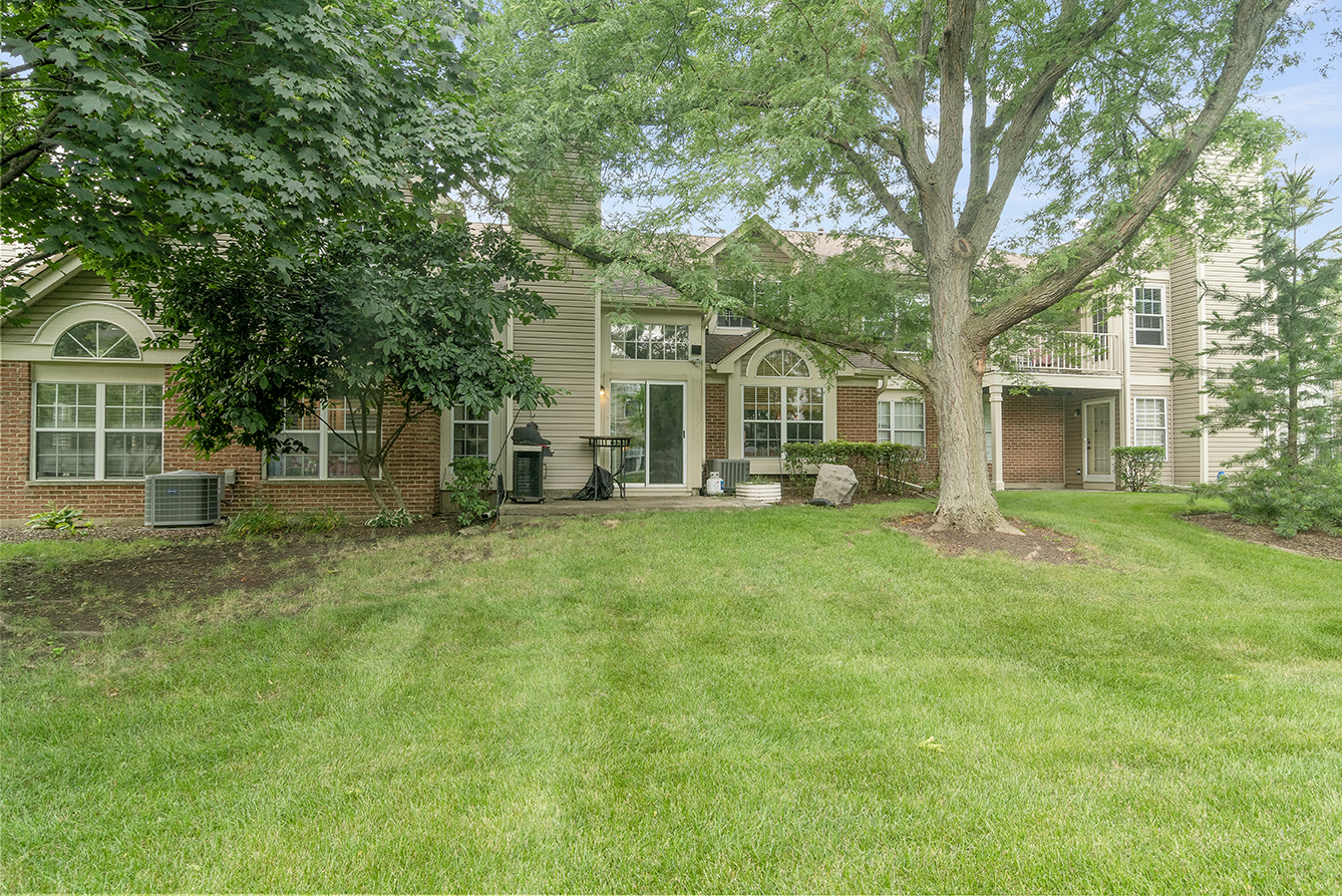 2833 Belle Lane, Unit 2833 Schaumburg, IL 60193 - Photo 23 of 23 a front view of a house with a garden