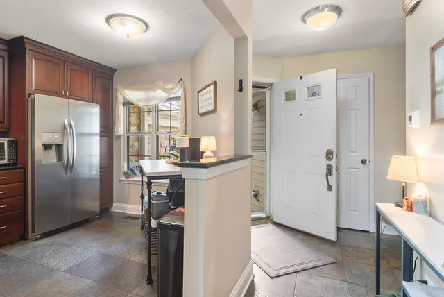a kitchen with a refrigerator and a sink