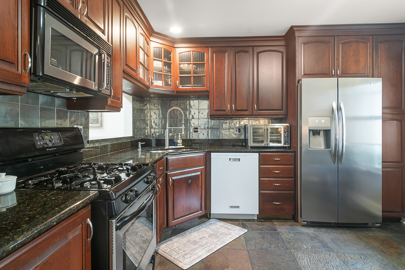 2833 Belle Lane, Unit 2833 Schaumburg, IL 60193 - Photo 6 of 23 a kitchen with stainless steel appliances granite countertop a stove a refrigerator and a sink