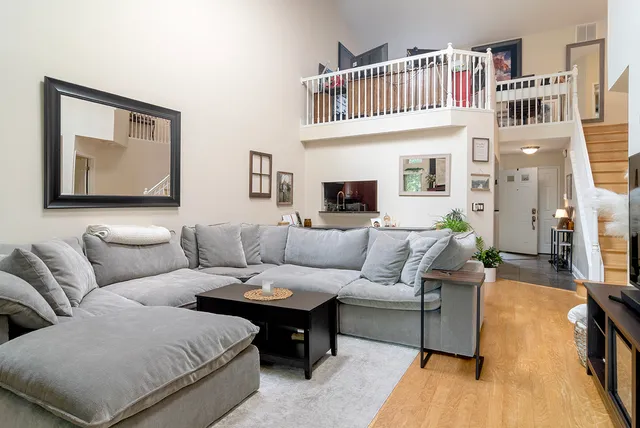 a living room with furniture a rug and a window