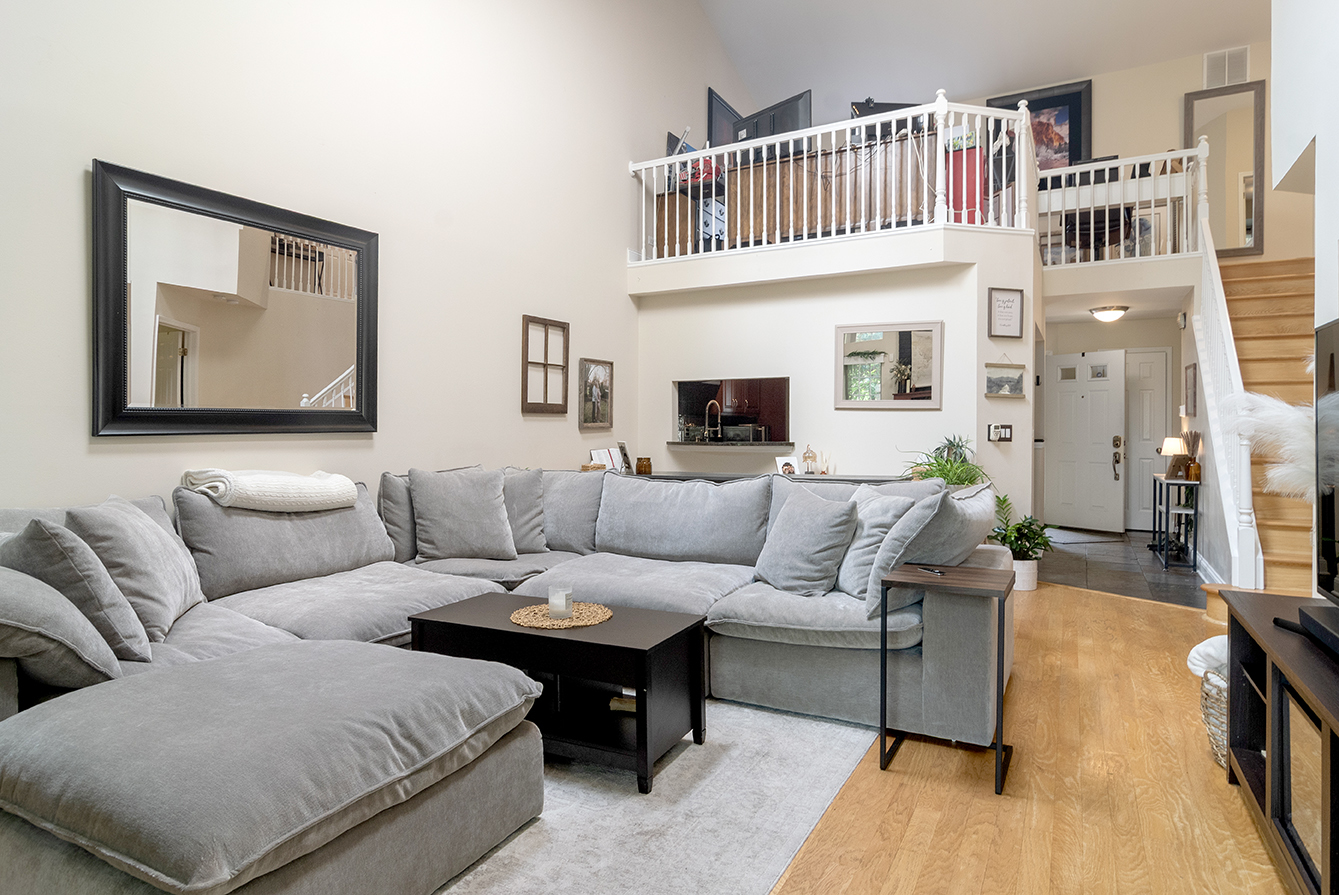 2833 Belle Lane, Unit 2833 Schaumburg, IL 60193 - Photo 9 of 23 a living room with furniture a rug and a window