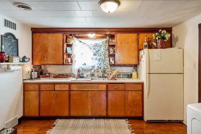 a kitchen with appliances a sink and cabinets