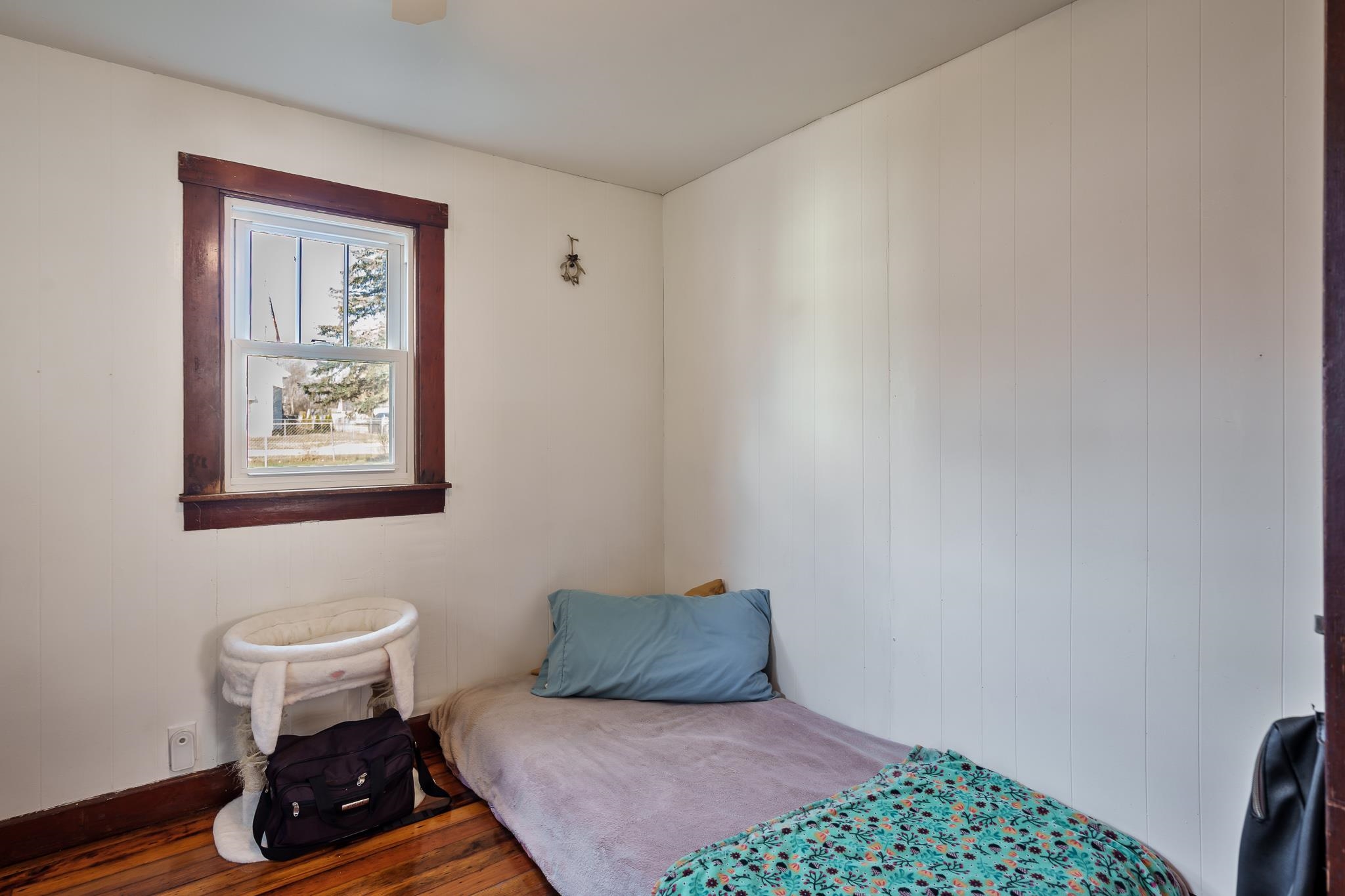 827 Sawyer Road Rockford, IL 61109 - Photo 14 of 24 a bedroom with a bed and wooden floor