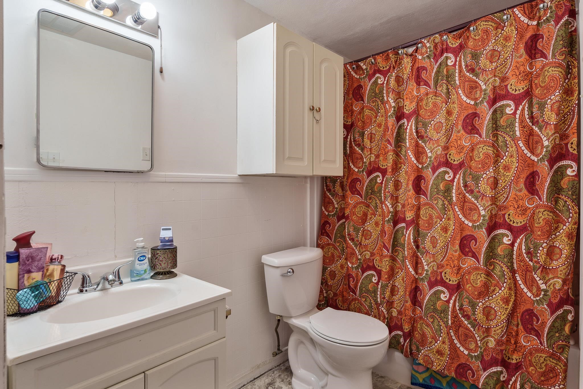 827 Sawyer Road Rockford, IL 61109 - Photo 17 of 24 a bathroom with a sink a toilet and a mirror