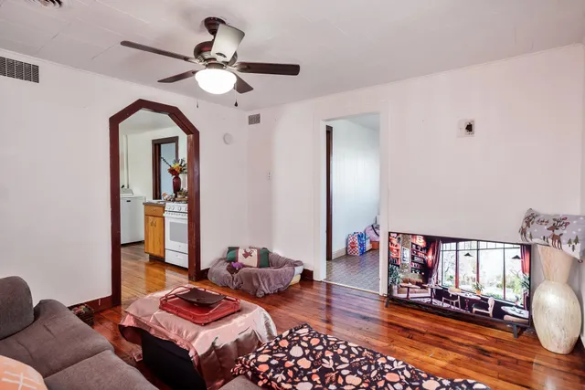 a bedroom with bed and wooden floor