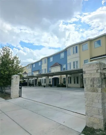 a view of house with yard and sitting area
