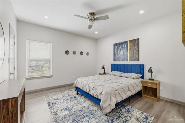 a bedroom with a large bed and a chandelier