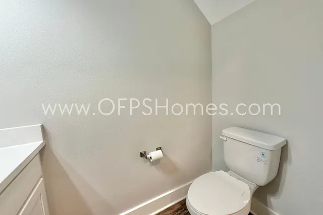 a white toilet sitting next to a white sink