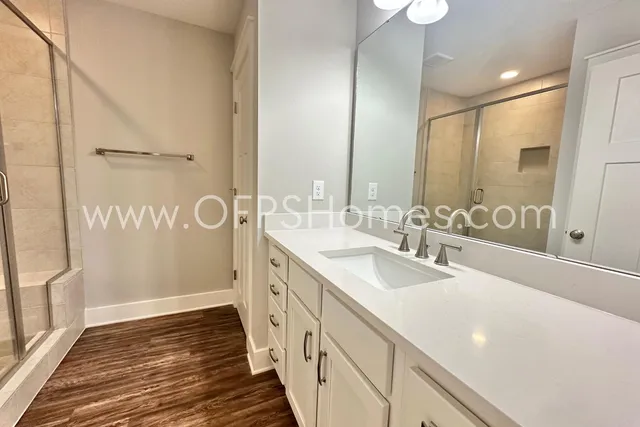 a bathroom with double vanity and mirrors