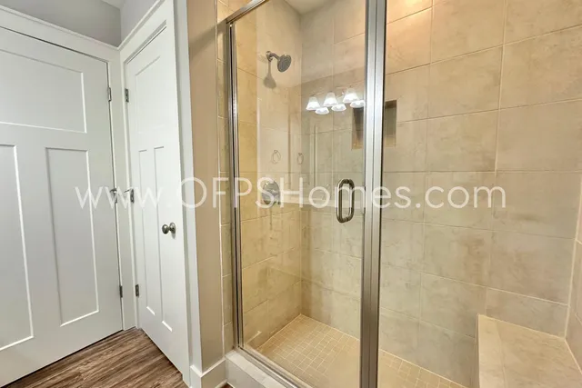a bathroom with a glass shower door