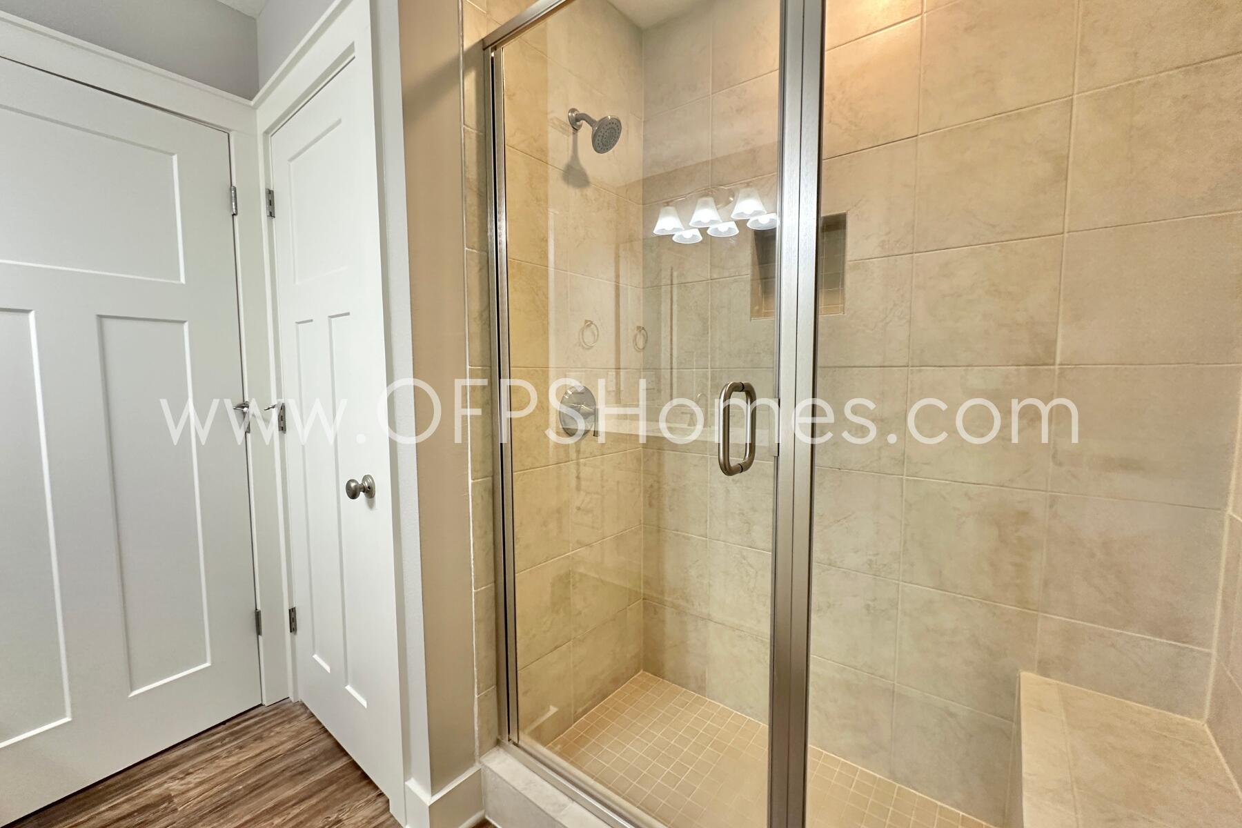 400 Mattie M Kelly Boulevard, Unit 54 Destin, FL 32541 - Photo 18 of 29 a bathroom with a glass shower door