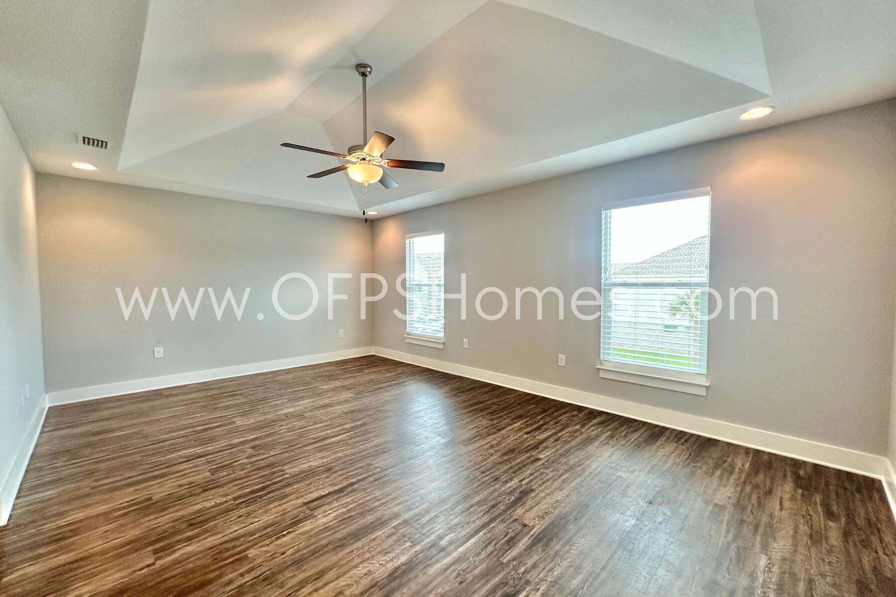 400 Mattie M Kelly Boulevard, Unit 54 Destin, FL 32541 - Photo 21 of 29 an empty room with wooden floor and windows