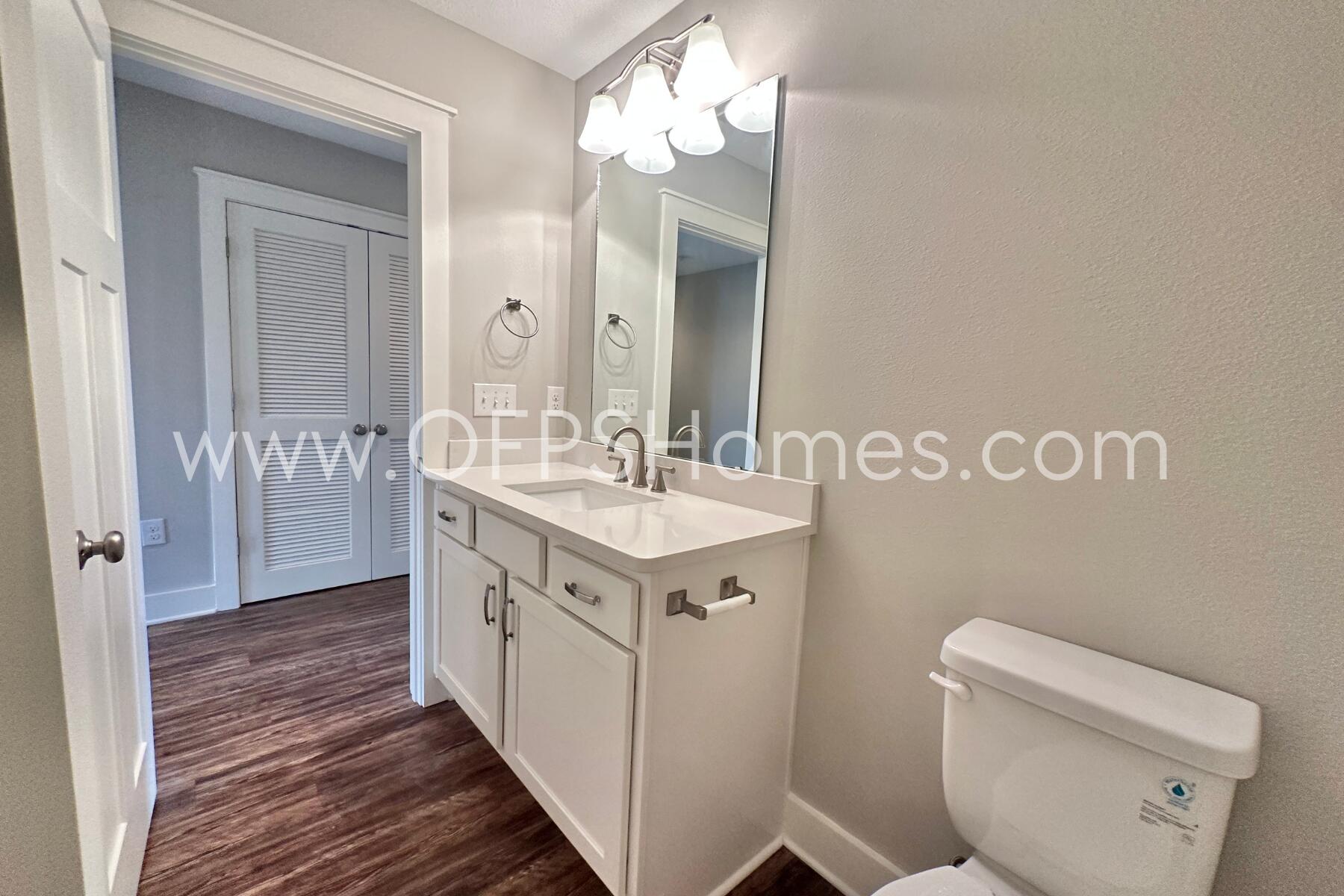 400 Mattie M Kelly Boulevard, Unit 54 Destin, FL 32541 - Photo 24 of 29 a bathroom with a sink a toilet and a mirror