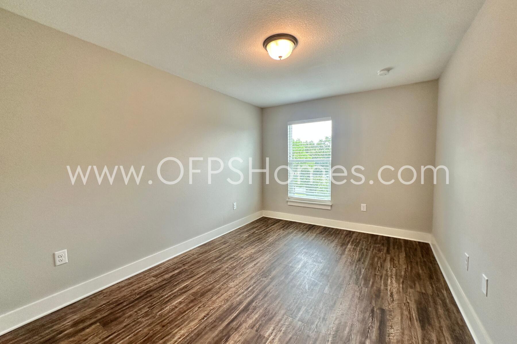 400 Mattie M Kelly Boulevard, Unit 54 Destin, FL 32541 - Photo 26 of 29 a view of an empty room with wooden floor and a window